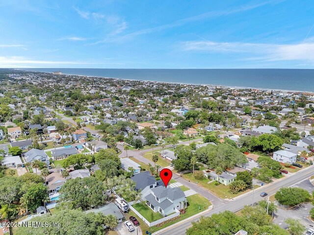 aerial view of property's location with a large body of water and nearby suburban area