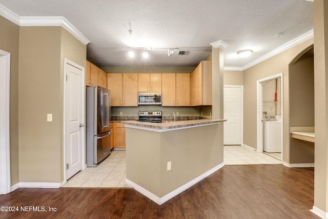 12700 Bartram Park Blvd Unit 123, Jacksonville, FL 32258 - kitchen with appliances with stainless steel finishes, washer / dryer, light wood-type flooring, crown molding, and light brown cabinetry