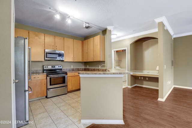 12700 Bartram Park Blvd Unit 123, Jacksonville, FL 32258 - kitchen with appliances with stainless steel finishes, ornamental molding, a peninsula, light countertops, and a textured ceiling