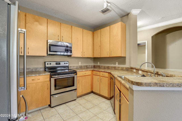 12700 Bartram Park Blvd Unit 123, Jacksonville, FL 32258 - kitchen featuring appliances with stainless steel finishes, light brown cabinetry, a peninsula, a textured ceiling, and light tile patterned floors