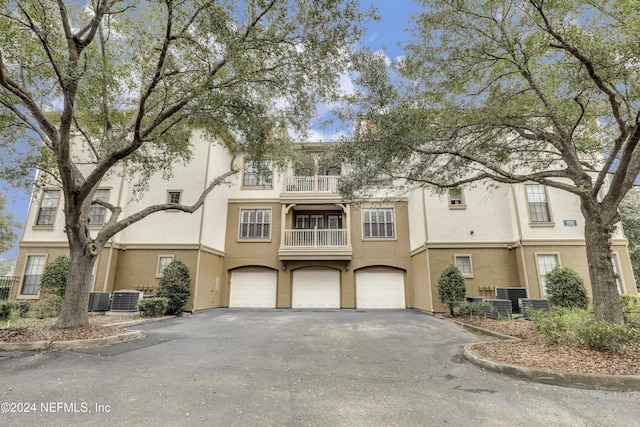 12700 Bartram Park Blvd Unit 123, Jacksonville, FL 32258 - view of property with a balcony, driveway, stucco siding, central AC unit, and a garage