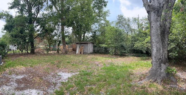 10258 Elmhurst Dr, Jacksonville, FL 32218 - view of yard featuring a shed, an outbuilding, and fence