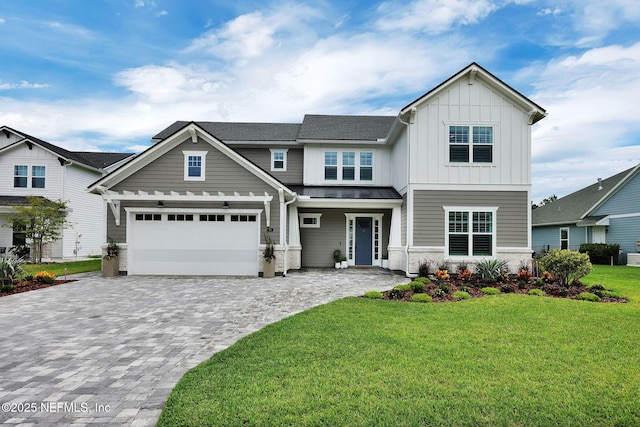 94 Anthem Ridge Dr, Ponte Vedra, FL 32081 - view of front of home featuring board and batten siding, decorative driveway, a standing seam roof, a front lawn, and metal roof