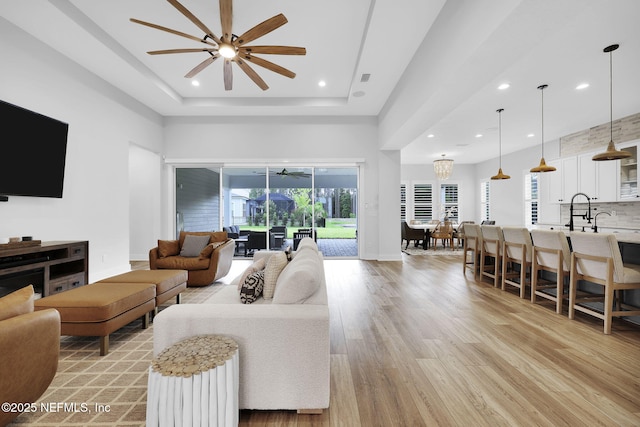 94 Anthem Ridge Dr, Ponte Vedra, FL 32081 - living room with a ceiling fan, light wood-style floors, recessed lighting, a raised ceiling, and baseboards
