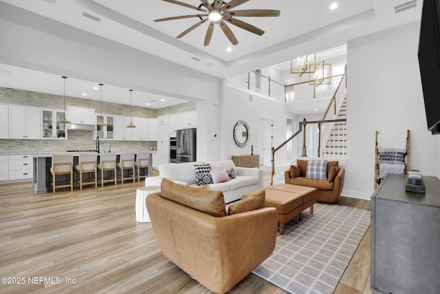 94 Anthem Ridge Dr, Ponte Vedra, FL 32081 - living room featuring a ceiling fan, light wood finished floors, stairway, a chandelier, and recessed lighting