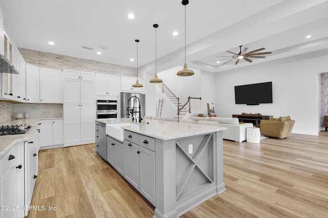 94 Anthem Ridge Dr, Ponte Vedra, FL 32081 - kitchen with a sink, gray cabinetry, recessed lighting, light wood-style flooring, and decorative backsplash