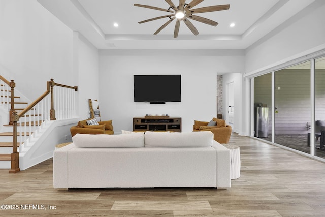 94 Anthem Ridge Dr, Ponte Vedra, FL 32081 - living room featuring a ceiling fan, light wood-style flooring, a raised ceiling, stairs, and recessed lighting