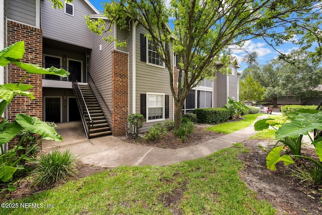 10000 Gate Pkwy Unit 2123, Jacksonville, FL 32246 - back of house featuring stairs and brick siding