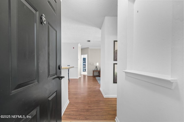 10000 Gate Pkwy Unit 2123, Jacksonville, FL 32246 - foyer entrance with a textured ceiling, dark wood-style flooring, and baseboards