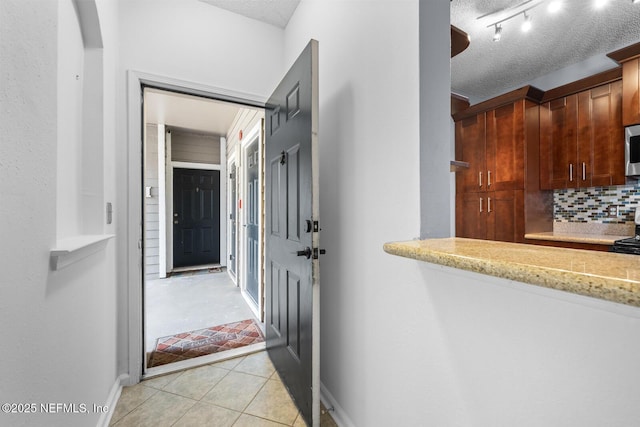 10000 Gate Pkwy Unit 2123, Jacksonville, FL 32246 - hallway with a textured ceiling, light tile patterned flooring, and baseboards