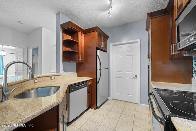10000 Gate Pkwy Unit 2123, Jacksonville, FL 32246 - kitchen featuring stainless steel appliances, a sink, light tile patterned floors, light stone counters, and open shelves