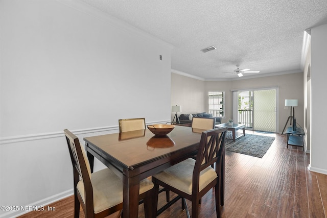 10000 Gate Pkwy Unit 2123, Jacksonville, FL 32246 - dining room featuring a ceiling fan, a textured ceiling, wood finished floors, crown molding, and baseboards