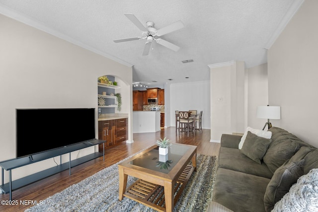 10000 Gate Pkwy Unit 2123, Jacksonville, FL 32246 - living room featuring a textured ceiling, ornamental molding, dark wood-style flooring, and ceiling fan
