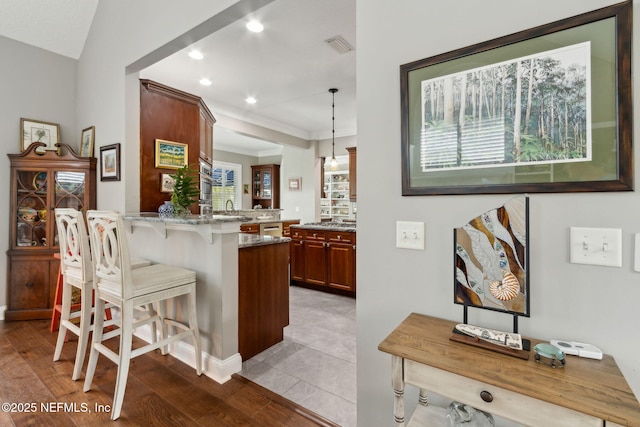 96321 Bay View Dr, Fernandina Beach, FL 32034 - bar area with decorative light fixtures, recessed lighting, a sink, ornamental molding, and light wood-style flooring