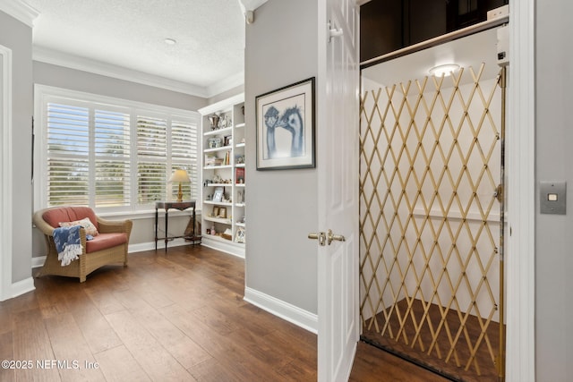 96321 Bay View Dr, Fernandina Beach, FL 32034 - living area featuring baseboards, ornamental molding, elevator, wood finished floors, and a textured ceiling