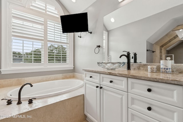 96321 Bay View Dr, Fernandina Beach, FL 32034 - bathroom featuring lofted ceiling, vanity, and a bath