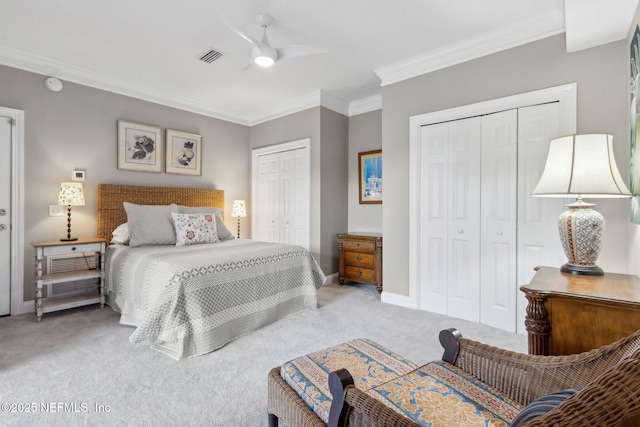 96321 Bay View Dr, Fernandina Beach, FL 32034 - bedroom with multiple closets, carpet floors, crown molding, baseboards, and a ceiling fan