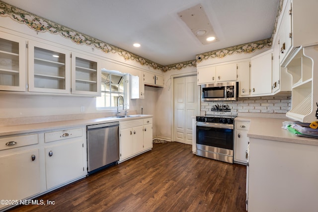5476 Waterside Dr, Jacksonville, FL 32210 - kitchen with stainless steel appliances, a sink, light countertops, white cabinets, and recessed lighting