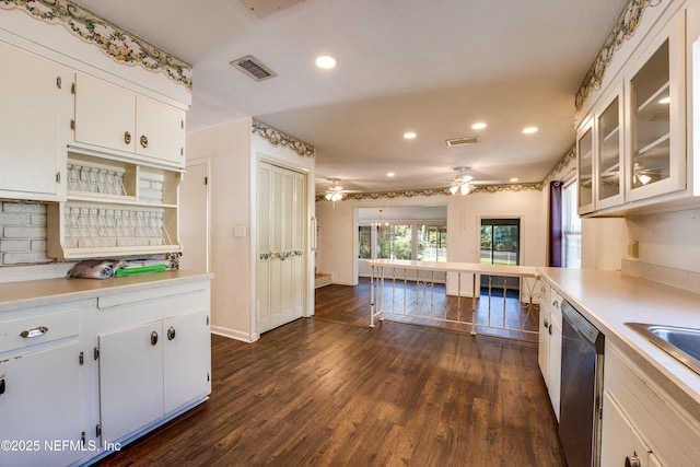 5476 Waterside Dr, Jacksonville, FL 32210 - kitchen with stainless steel dishwasher, recessed lighting, white cabinetry, light countertops, and dark wood finished floors
