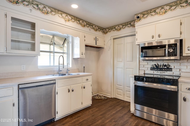 5476 Waterside Dr, Jacksonville, FL 32210 - kitchen with stainless steel appliances, a sink, white cabinets, light countertops, and recessed lighting