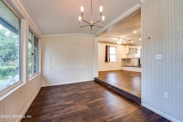 5476 Waterside Dr, Jacksonville, FL 32210 - unfurnished dining area with wood finished floors, a chandelier, ornamental molding, lofted ceiling, and wallpapered walls