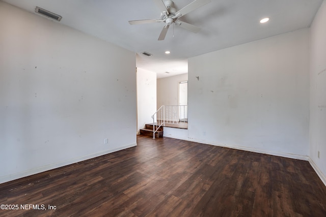 5476 Waterside Dr, Jacksonville, FL 32210 - empty room with a ceiling fan, wood finished floors, baseboards, recessed lighting, and stairs