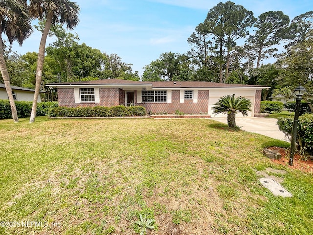 ranch-style home featuring brick siding, driveway, an attached garage, and a front yard