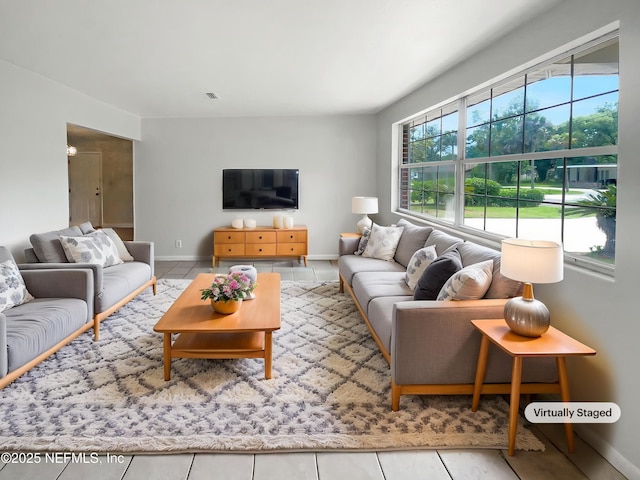 living area with tile patterned flooring and baseboards