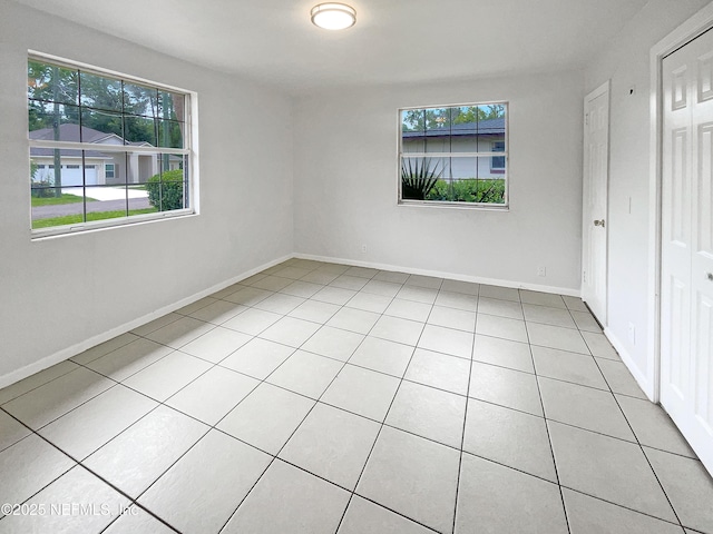 unfurnished bedroom featuring tile patterned floors and baseboards