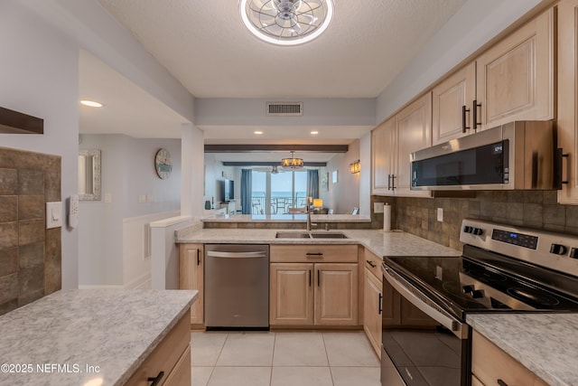 1301 1st St S Unit 1403, Jacksonville Beach, FL 32250 - kitchen with appliances with stainless steel finishes, a sink, light brown cabinets, a chandelier, and light tile patterned flooring