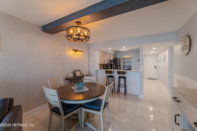 1301 1st St S Unit 1403, Jacksonville Beach, FL 32250 - dining room with light tile patterned flooring, a chandelier, recessed lighting, beam ceiling, and baseboards