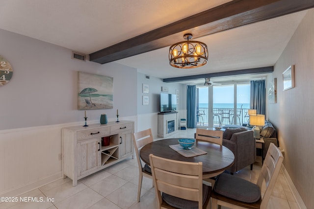 1301 1st St S Unit 1403, Jacksonville Beach, FL 32250 - dining area featuring a chandelier, beamed ceiling, light tile patterned flooring, baseboards, and a ceiling fan
