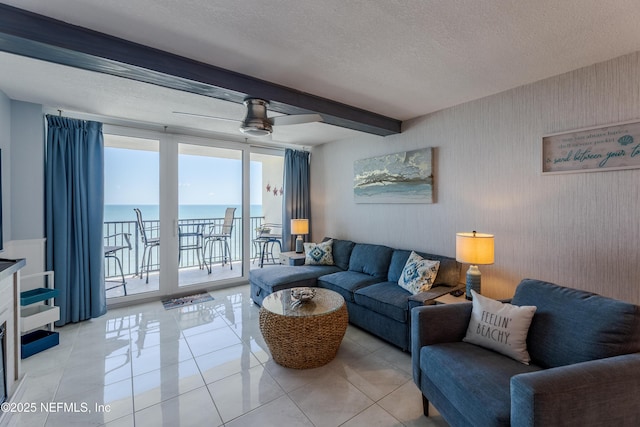 1301 1st St S Unit 1403, Jacksonville Beach, FL 32250 - living area featuring beam ceiling, a water view, a textured ceiling, light tile patterned flooring, and ceiling fan