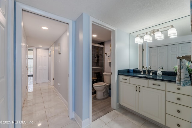 1301 1st St S Unit 1403, Jacksonville Beach, FL 32250 - bathroom featuring tile patterned floors, toilet, vanity, a stall shower, and baseboards