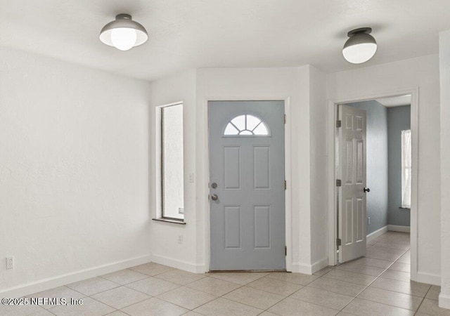 2885 Sand Castle Ln, Jacksonville, FL 32233 - foyer entrance with light tile patterned floors and baseboards