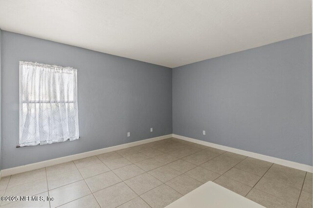 2885 Sand Castle Ln, Jacksonville, FL 32233 - tiled spare room featuring baseboards