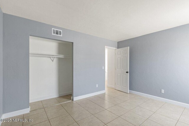2885 Sand Castle Ln, Jacksonville, FL 32233 - unfurnished bedroom featuring a closet, tile patterned flooring, and baseboards