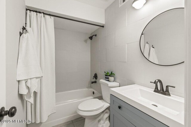 2885 Sand Castle Ln, Jacksonville, FL 32233 - bathroom with shower / bath combo, vanity, toilet, tile walls, and tile patterned flooring