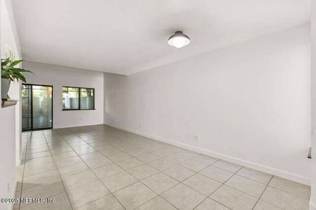 2885 Sand Castle Ln, Jacksonville, FL 32233 - spare room featuring light tile patterned flooring and baseboards