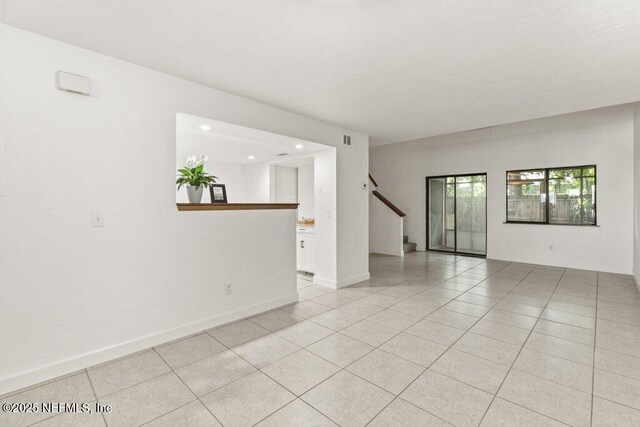 2885 Sand Castle Ln, Jacksonville, FL 32233 - spare room with light tile patterned floors, recessed lighting, stairs, and baseboards