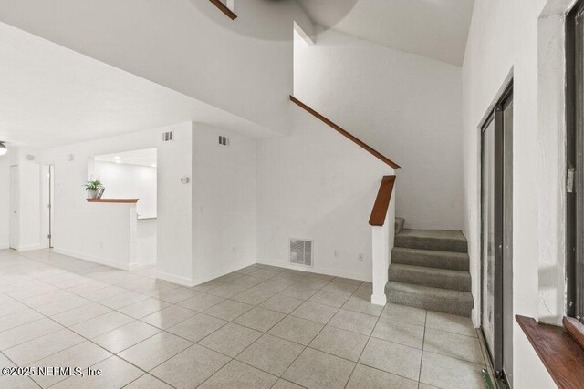 2885 Sand Castle Ln, Jacksonville, FL 32233 - unfurnished living room with tile patterned floors and stairs
