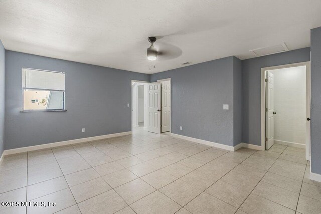 2885 Sand Castle Ln, Jacksonville, FL 32233 - empty room with attic access, light tile patterned flooring, baseboards, and ceiling fan