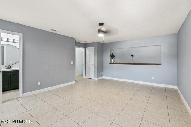2885 Sand Castle Ln, Jacksonville, FL 32233 - spare room with baseboards and light tile patterned floors