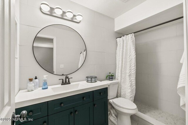 2885 Sand Castle Ln, Jacksonville, FL 32233 - full bath with a tile shower, vanity, toilet, and tile walls