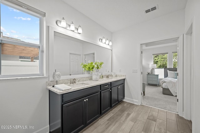 107 Park Lake Dr, Ponte Vedra, FL 32081 - ensuite bathroom with wood finished floors, baseboards, and double vanity