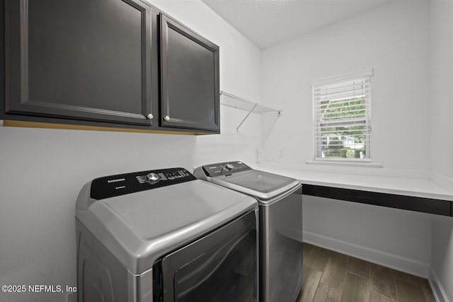 107 Park Lake Dr, Ponte Vedra, FL 32081 - clothes washing area with cabinet space, washing machine and dryer, wood finished floors, and baseboards