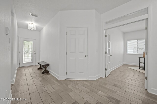107 Park Lake Dr, Ponte Vedra, FL 32081 - entrance foyer with wood tiled floors, baseboards, and a textured ceiling
