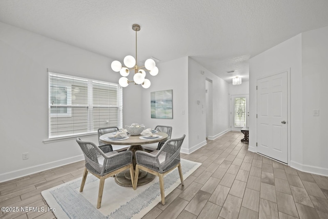 107 Park Lake Dr, Ponte Vedra, FL 32081 - dining room with a chandelier, wood finished floors, baseboards, and a textured ceiling