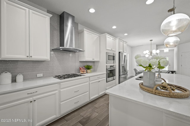 107 Park Lake Dr, Ponte Vedra, FL 32081 - kitchen featuring stainless steel appliances, wall chimney range hood, backsplash, white cabinetry, and recessed lighting