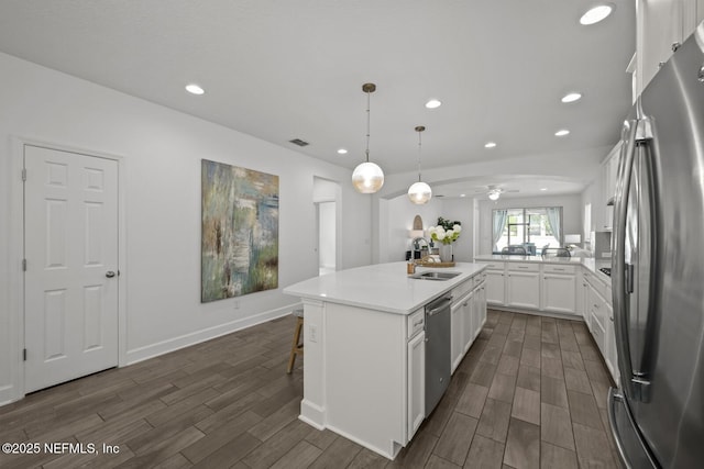 107 Park Lake Dr, Ponte Vedra, FL 32081 - kitchen with stainless steel appliances, a sink, dark wood finished floors, white cabinetry, and recessed lighting